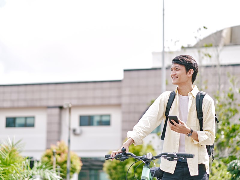 Boy is standing with bicycle