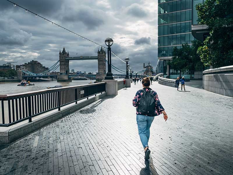 A women walking across a bridge
