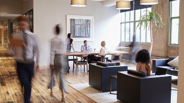 Business people at work in a busy luxury office space