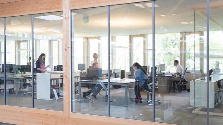 Exterior view of employees are working inside the real estate office