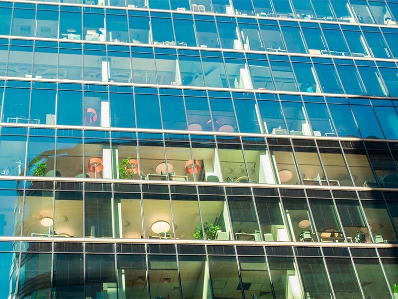 side glass view of a real estate building to boost energy efficiency