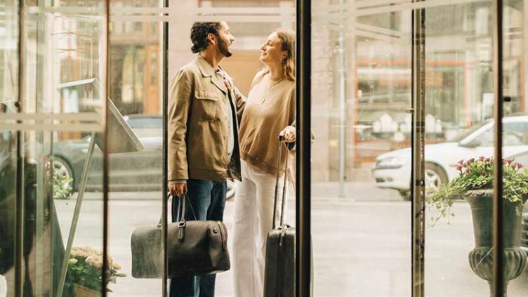 A man women holding bags and looking