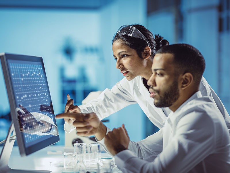 Two people working in lab.